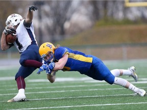 Saskatoon Hilltops' Colton Holmes tackles Regina Thunder's Levi Paul during the Prairie Football Conference final at SMF Field in Saskatoon on October 22, 2017.