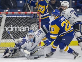 Victoria Royals goalie Griffen Outhouse stops a shot from Saskatoon Blades forward Gage Ramsay during first-period WHL action in Saskatoon on Tuesday, October 24, 2017.