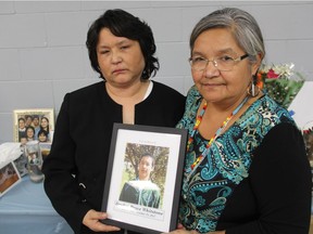 Dorothy Laboucane, the mother of 22-year-old Brydon Bryce Whitstone, left, holds a photo of her son alongside Whitstone's aunt, Ruth Lewis at the Onion Lake Communiplex Hall on Oct. 28, 2017. Dozens of family members, friends and community members, gathered for Whitstone's funeral after he was shot and killed in an RCMP-involved shooting on Oct. 21, 2017.