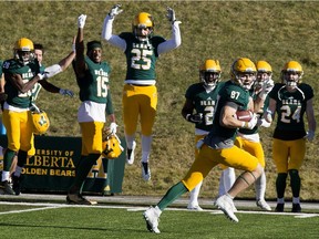 Alberta's Colby Miller runs to the end zone as teammates cheer him on Saturday in Edmonton.