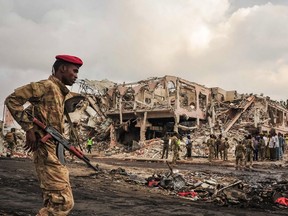 Somali soldiers patrol on the scene of the explosion of a truck bomb in the centre of Mogadishu, on October 15, 2017.