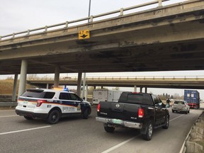 Police and emergency crews responded on Oct. 20, 2017, after a semi-tractor unit crashed into the Circle Drive East overpass at Highway 11. Traffic in the area was restricted during the clean-up. (Morgan Modjeski / Saskatoon StarPhoenix)