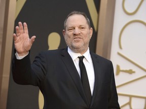 FILE - In this March 2, 2014 file photo, Harvey Weinstein arrives at the Oscars in Los Angeles. Weinstein has been fired from The Weinstein Co., effective immediately, following new information revealed regarding his conduct, the company's board of directors announced Sunday, Oct. 8, 2017. (Photo by Jordan Strauss/Invision/AP, File)