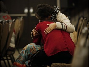 Family members comfort each other at the opening day hearings of the National Inquiry into Missing and Murdered Indigenous Women and Girls in Winnipeg, Monday, October 16, 2017. THE CANADIAN PRESS/John Woods ORG XMIT: JGW114
JOHN WOODS,
