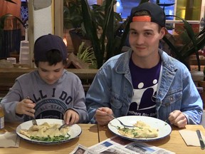 Gabriel Arcand, left, and Paul Carrobourg, a Big Brother-Little Brother team, enjoy some poutine at Drift Sidewalk Café & Vista Lounge