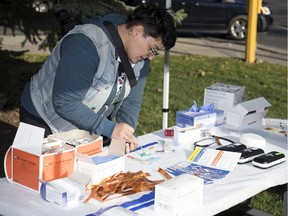 Collective Resistance to Injustice (CRI) Vancouver, a group formed out of the fentanyl crisis in British Columbia, set up an educational safe injection/overdose prevention site at city hall on Wednesday to educate the public. Frontline worker Nesa Tousi demonstrates some of the equipment used at the site.