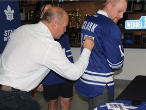 Former Toronto Maple Leaf player Wendel Clark signs autographs Saturday, Oct. 21, in his hometown of Kelvington, Sask., during Wendel Clark Day. The town renamed the street that runs in front of the local arena Wendel Clark Way. (Photo by Michael Oleksyn for the Saskatoon StarPhoenix)