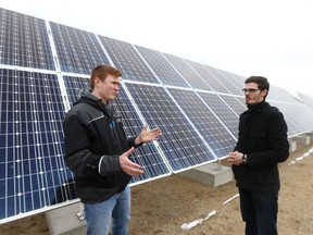 Sask. Polytechnic mechanical engineering students Kevin Wilson and Cody Leusca explains how the solar panel's angle changes to optimize sun exposure at one of the first solar power generation co-operatives in the province at the Landfill Gas Power Generation Facility in Saskatoon on April 25, 2017. (Michelle Berg / Saskatoon StarPhoenix)