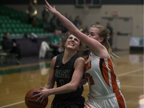 Huskies point guard Libby Epoch goes to shoot the ball as Thompson Rivers guard Makayla Hoey defends during Canada West women's basketball action at the PAC facility in Saskatoon on Saturday, Nov. 11, 2017.