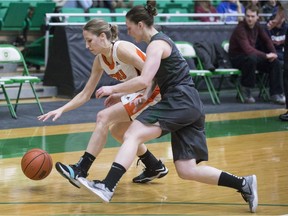 Wolfpacks guard Emma Piggin goes to move the ball past Huskies guard Sabine Dukate during the game at the PAC on Nov. 11, 2017.