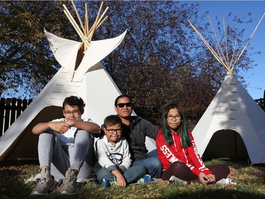 McKenzie Lafond, Lex Lafond, Ace Lafond and Tala Lafond sit for a family photo after building teepees in their backyard in Saskatoon.