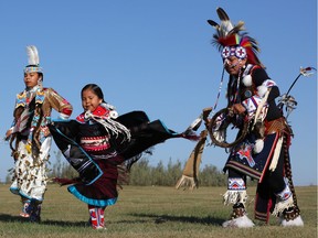 11-year-old Omiyosiw Nazbah Warren and six-year-old Kiihibaa Acahkos Warren dance with their dad TJ Warren at Wanuskewin Heritage Park. Both of his daughters have been active in powwow from a young age. Warren said it's not only good for their health, it helps ground them in life and connect to the land and their ancestors.