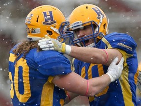 Saskatoon Hilltops  Cam Schnitzler and Adam Benkic celebrate a play during the Canadian Junior Football League semifinal against Vancouver Island Raiders at SMF Field in Saskatoon on October 29, 2017.
