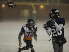 High school football players had to brave the snow Friday night at the 3A city high school football final.