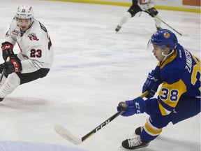 Saskatoon Blades forward Alec Zawatsky hones in on the puck in front of Moose Jaw Warrior player Tate Popple during WHL action Wednesday at SaskTel Centre.