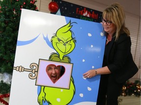 Saskatoon City Hospital Foundation CEO Steve Shannon and Saskatoon Zoo Foundation Executive Director Dawn Woroniuk get playful with a grinch display during an announcement for the new BHP Enhanted Forest display "The Grinch in Whoville" sponsored by the RUSH Lacrosse Club in Saskatoon on November 14, 2017. (Michelle Berg / Saskatoon StarPhoenix)