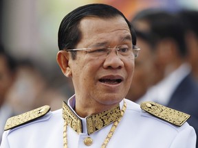 Cambodia's Prime Minister Hun Sen waits to attend the Independence Day celebrations in Phnom Penh, Cambodia. The government accuses the opposition Cambodia National Rescue Party of involvement in a plot to topple the government and has asked the judiciary to dissolve it. CNRP officials have denied the charges, saying they are politically motivated.