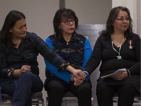 From left to right, Commissioner Michele Audette, Myrna LaPlante, who is part of local support group Women Walking Together, and Darlene Okemaysim-Sicotte, representing Saskatoon Mayor Charlie Clark, sit together during the opening ceremonies for the Missing and Murdered Indigenous Women and Girls inquiry in Saskatoon on Monday, Nov. 20, 2017.