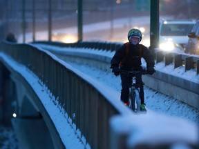 A cyclist bundled up during his morning commute before sunrise in Saskatoon on Nov. 20, 2017.