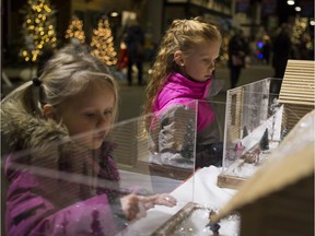 Cosette Boldt, left, and Myelle Boldt look at miniature cabins during the annual Festival of Trees at the Western Development Museum in Saskatoon, SK on Friday, November 24, 2017. (Saskatoon StarPhoenix/Kayle Neis)