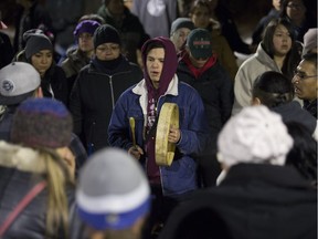 Rollin Baldhead (center) plays the drum during a round dance in memory of Marlene Bird at City Hall in Saskatoon, SK on Tuesday, November 28, 2017. Bird, 50, died in Prince Albert on Monday. She lost both her legs and much of her eyesight after she was attacked and set on fire in a Prince Albert alley in 2014. (Saskatoon StarPhoenix/Kayle Neis)