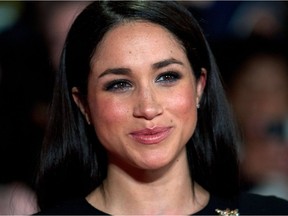 (FILES) This file photo taken on November 11, 2013 shows  US actress Meghan Markle as she poses for pictures on the red carpet upon arrival for the world premier of the film "The Hunger Games: Catching Fire" in Leicester Square, central London.