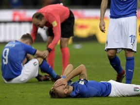 Italian players react after failing to reach the World Cup for the first time since 1958.