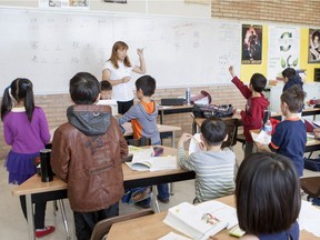 An instructor leads first grade students at a Chinese language school held at Aden Bowman Collegiate on Saturday May 5th, 2015.