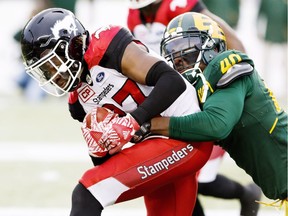 Calgary Stampeders' Tunde Adeleke (27) gets wrapped up by Edmonton Eskimos' Kevin Jackson (40) during first half CFL action in Edmonton, Alta., on Saturday October 28, 2017. THE CANADIAN PRESS/Amber Bracken ORG XMIT: AKB104
AMBER BRACKEN,