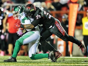 Saskatchewan Roughriders quarterback Kevin Glenn is sacked by Charleston Hughes of the Calgary Stampeders during CFL football on Friday, October 20, 2017.