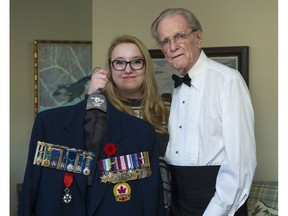 Grade 12 Riffel High School student Athena Brecht, left, holds Harold Hague's Legion jacket and his many medals at his home at Marian Chateau. Brecht made a film about the celebrated Second World War veteran through an intergenerational partnership between Revera, operator of Marian Chateau, and Reel Youth, a not-for-profit that helps youths create films about social issues.
