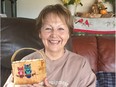 Joan Beatty, former CBC journalist and NDP cabinet minister, holds a birch bark basket made by Mitch Fineday of Deschambault Lake.