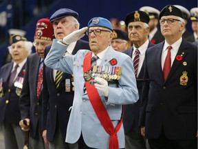 Veterans salute during the largest indoor Remembrance Day service in Canada on Nov. 11, 2015 in Saskatoon.