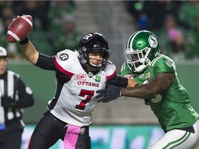 The Saskatchewan Roughriders will need to create some pressure on Ottawa Redblacks quarterback Trevor Harris in Sunday's CFL playoff game. Harris is shown being pursued by the Riders' A.C. Leonard on Oct. 13 at Mosaic Stadium.