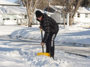 Nathan Rudd clears snow from the sidewalk and street near his home in the 900 block of Second Street East in Saskatoon, SK. on Saturday, February 7, 2015. The city's snow clearing plans for 2018 aim to get greater compliance on residential sidewalk clearing. (LIAM RICHARDS/THE STAR PHOENIX)