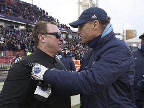 Saskatchewan Roughriders head coach Chris Jones congratulates his opposite number, the Toronto Argonauts' Marc Trestman, after Sunday's CFL East Division final.