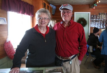 Staring in late November, Cora Greer and Bob Mason sell Christmas trees out of a red barn on their farm near Kenaston.