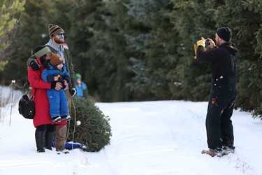 Leo Johnston takes a photo of family members during their trip to Mason Tree Farm near Kenaston.