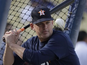 Houston Astros manager A.J. Hinch hits balls before Game 7 of baseball's World Series against the Los Angeles Dodgers Wednesday, Nov. 1, 2017, in Los Angeles. (AP Photo/David J. Phillip)