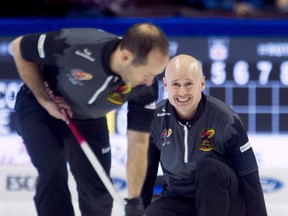 Skip Kevin Koe, of Calgary, watches second Brent Laing sweep his rock earlier this week. (THE CANADIAN PRESS)