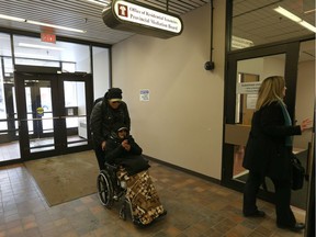 Jonathan McLeod pushes his mother Mary-Ann into a hearing at Saskatchewan's Office of Residential Tenancies on Tuesday December 5.