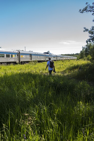 A Canada 150 traveller walks back to the train during a stop at one of the stations.