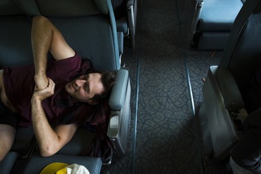 Zack Mazurek tries to get comfortable on the train. It can be challenging for long-term train travellers to find a comfortable way to sleep.