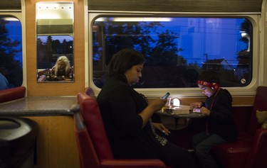 Tristan Hardy (left) plays the ukulele on the train from Montreal to Halifax in the communal car.