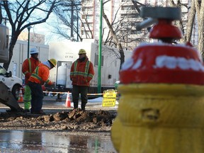 City workers repair a water main valve at 24th Street and 6th Avenue in Saskatoon on December 7, 2017.
