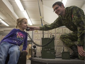 SASKATOON,SK--DECEMBER 08/2017-1209 Standalone Radio Santa- Katherine Reier, age 5, speaks to Santa on specialized radio equipment held by Sargent Nathan Quennell with the local army reservists at Cardinal Leger School in Saskatoon, SK on Friday, December 8, 2017.