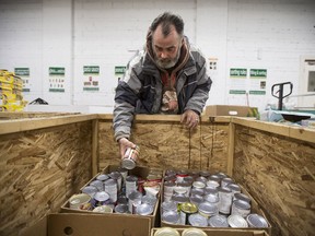 Volunteer Cal Carr sorts food items at the Saskatoon Food Bank in Saskatoon, SK on Friday, December 8, 2017.