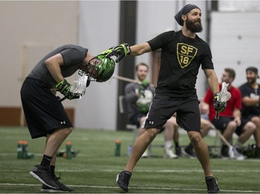 Defender Ryan Dilks, left, gets some extra tips from assistant coach Jimmy Quinlan during Saskatchewan Rush training camp at SaskTel Sports Centre in Saskatoon, SK on Saturday, December 9, 2017.