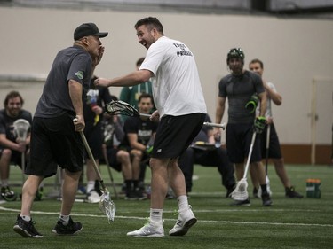 Forward Mark Matthews, right, checks on head coach and general manager Derek Keenan after Matthews hit him in the face with a pass during Saskatchewan Rush training camp at SaskTel Sports Centre in Saskatoon, SK on Saturday, December 9, 2017.