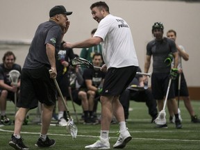 Forward Mark Matthews, right, checks on head coach and general manager Derek Keenan after Matthews hit him in the face with a pass during Saskatchewan Rush training camp at SaskTel Sports Centre in Saskatoon on Saturday.